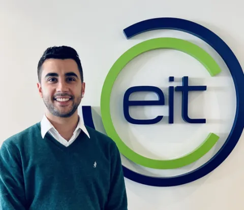 Photo of Francisco next to EIT logo