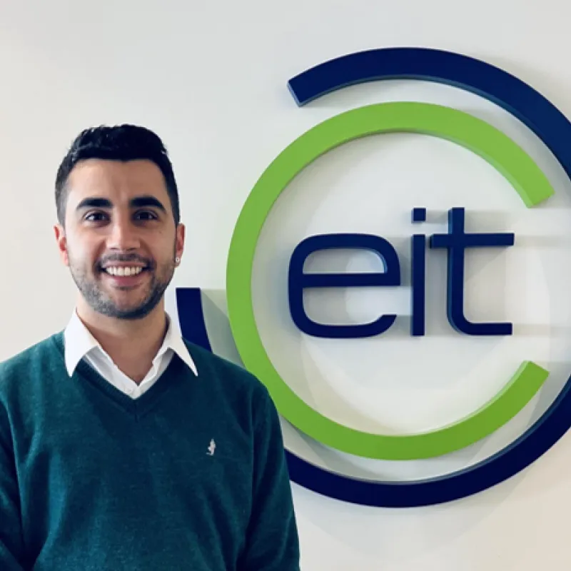 Photo of Francisco next to EIT logo